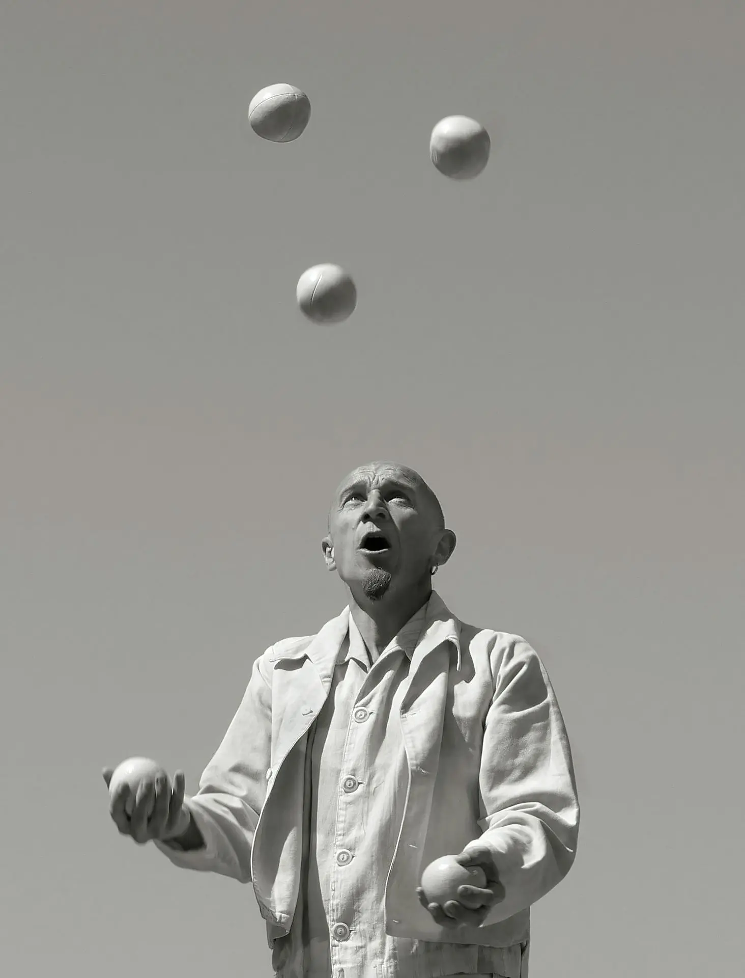 a man juggling balls into the air