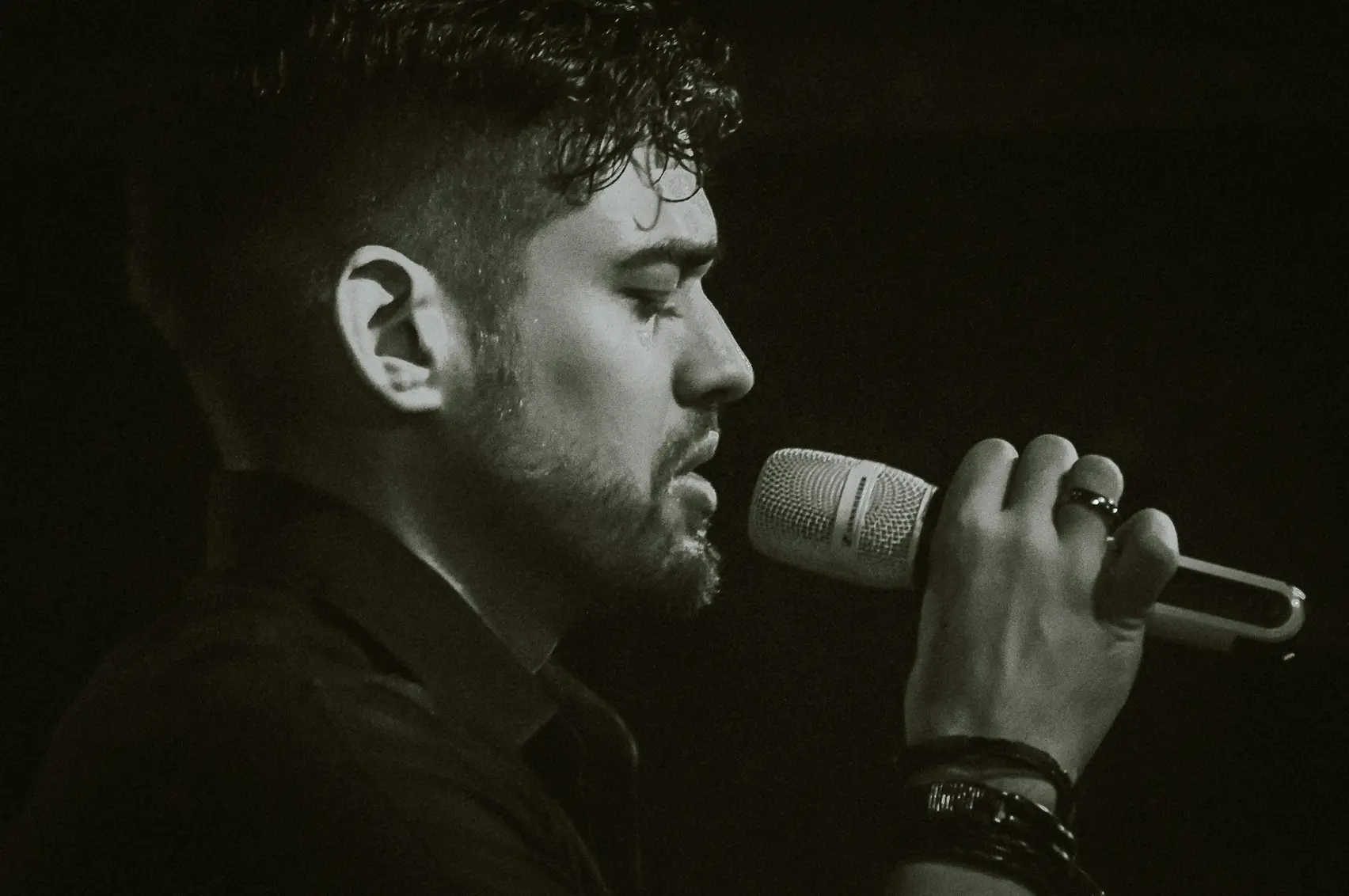 a man holding a microphone up to his mouth